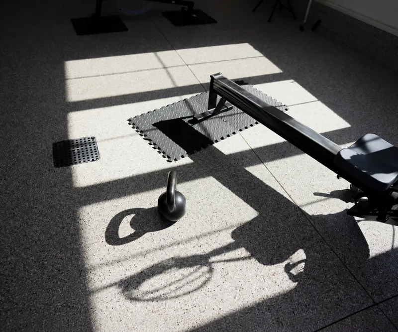 Coated floor in a home gym with bikes and weights